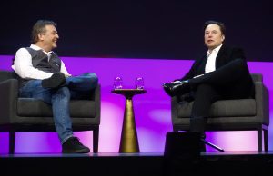 Elon Musk Acquires Twitter for $44 Billion Elon Musk stands at a podium with the Twitter logo displayed on a screen behind him.