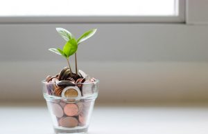 Philippine Startups Bleed Cash as Burn Rates Rise Founders and employees at a Philippine startup office reviewing financial documents amid declining cash reserves.