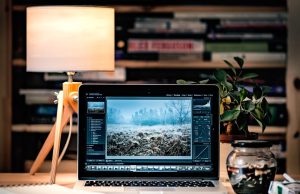 Apple Ships macOS, iOS, and iPadOS 18 on Same Day Apple devices displaying macOS Sequoia, iOS 18, and iPadOS 18 update screens side by side on a desk.