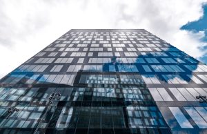HSBC Pays €294M to Settle Belgian Tax Case HSBC bank building exterior with a sign showing the company logo in Geneva, Switzerland.