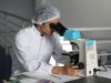 Abbott Buys Exact Sciences in $21B Cancer Deal A Cologuard test kit box sits on a table, representing the at-home colorectal cancer screening product central to Abbott's acquisition of Exact Sciences.