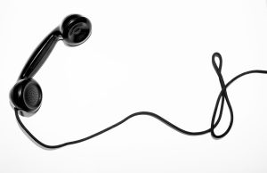 988 Lifeline Routes 24/7 Crisis Calls to Local Counselors Crisis counselor wearing headset answers a 988 call in a softly lit call center at night.