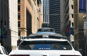 Waymo Runs 500,000 Paid Robotaxi Rides Weekly A Waymo autonomous vehicle drives through a city street with no driver behind the wheel during a paid passenger ride.