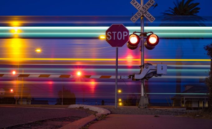 A damaged minibus sits at a railroad crossing in Chile's Bío-Bío Region after a train collision killed six people.