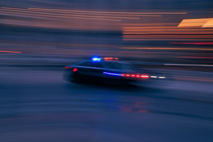 Police lights flash near a cordoned-off street in Rockford, Illinois, after a stabbing spree left four dead and seven wounded.