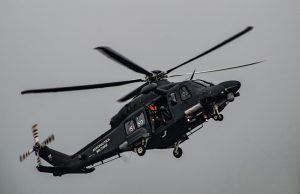 Bell 212 Helicopter Crash Kills Iran President Raisi A Bell 212 helicopter in flight over mountainous terrain, with twin engines and two blades visible, representing the aircraft involved in the Iran crash.