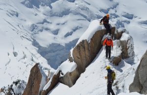 Italy Probes Mont Blanc Deaths of 3 Alpine Hikers Rescue helicopter hovers above Mont Blanc's snow-covered ridge as climbers traverse the steep alpine slope under clear summer sky