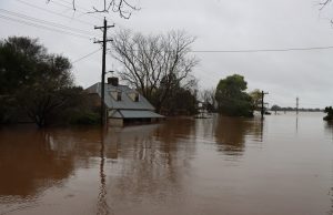 Kentucky Floods Close 500 Roads, Kill 2 Floodwaters cover a rural Kentucky road with submerged cars and debris near a hillside
