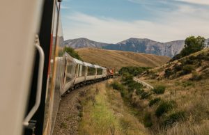 Kursk Bridge Blast Derails Train, Kills Worker A damaged railway bridge in Kursk Oblast with a derailed freight train and emergency responders assessing the scene.