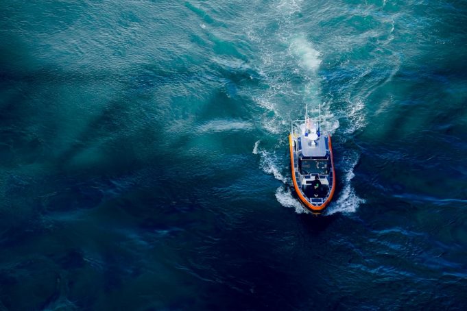 Rescue workers pull an injured migrant from a drifting boat off the coast of Mallorca.