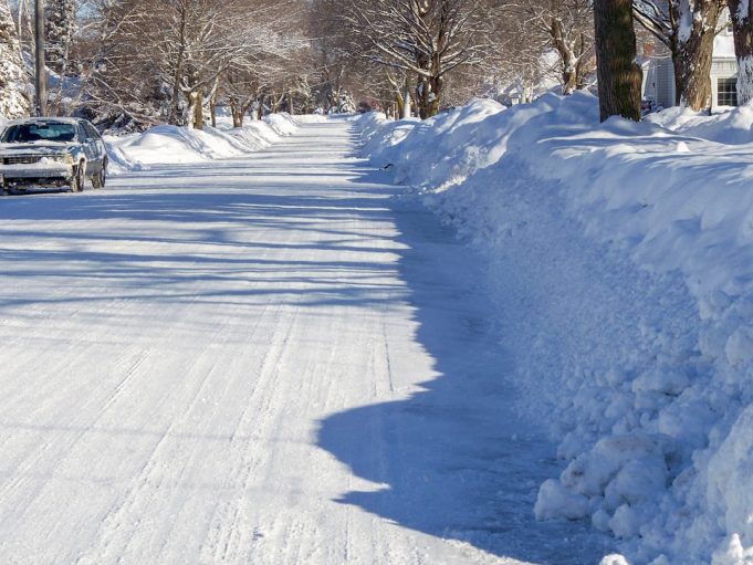 Rescue workers dig through deep snow to reach a collapsed wooden home in a rural Japanese mountain village.