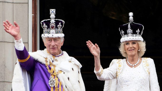 Charles III and Camilla sit enthroned in Westminster Abbey during their coronation ceremony, surrounded by clergy and royal family members.