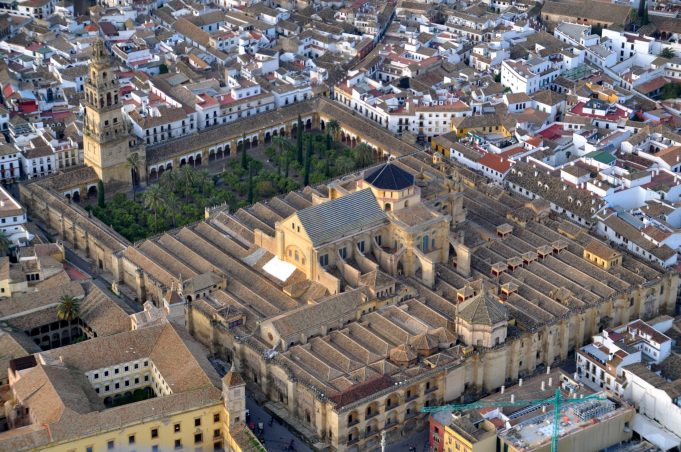 Fire at Córdoba Mosque-Cathedral in Spain quickly extinguished with minimal damage Orange flames and smoke billow from the chapel roof of the striped-arch Mosque-Cathedral while firefighters spray water hoses at night.