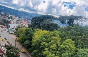 Bukavu Fire Kills 14 in Congo Dwelling Blaze Firefighters battling a blaze in a residential area of Bukavu, with smoke rising over Lake Kivu in the background.