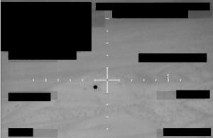 FBI Submits Redacted UAP Image to Pentagon AARO A monochrome image with a central crosshair reticle and a dark circular object, released by the FBI to the Pentagon's UAP office.