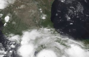Hurricane John Slams Mexico With Deadly Flooding Satellite image of Hurricane John approaching the coast of southern Mexico with a well-defined eye and spiral bands of clouds.