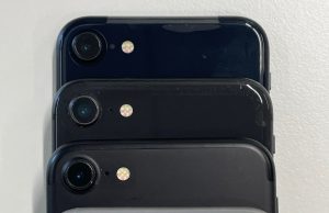 Apple Unveils iPhone 15 With USB-C Switch Apple CEO holds new iPhone 15 on stage, USB-C port visible under studio lights at Apple Park event.