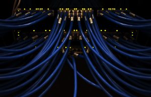 Meta Releases Llama Models to Researchers Meta AI logo on a server rack with data cables connecting to a glowing neural network visualization
