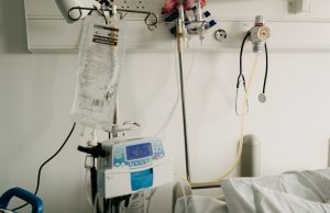 Philippines Unlocks Emergency Funds as COVID-19 Hits 33 Manila residents wearing face masks walk past a health advisory board listing COVID-19 cases in the capital city.