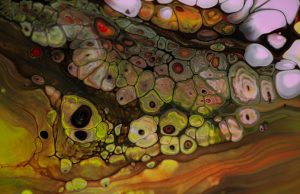 Synthetic Embryo Mimics Earliest Human Development A researcher examines a synthetic embryo-like structure under a microscope in a laboratory setting.