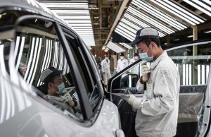 China Locks Down Wuhan Motor City Auto Plants Workers stand outside a closed Renault factory gate in Wuhan as Chinese authorities enforce a strict quarantine lockdown.