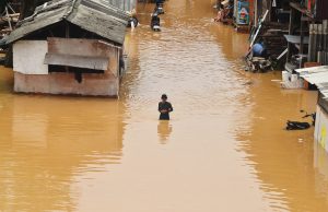 Oman UAE Flood Death Toll Hits 20 Rescue workers wade through a flooded street in Dubai after record rainfall submerged roads and damaged buildings.